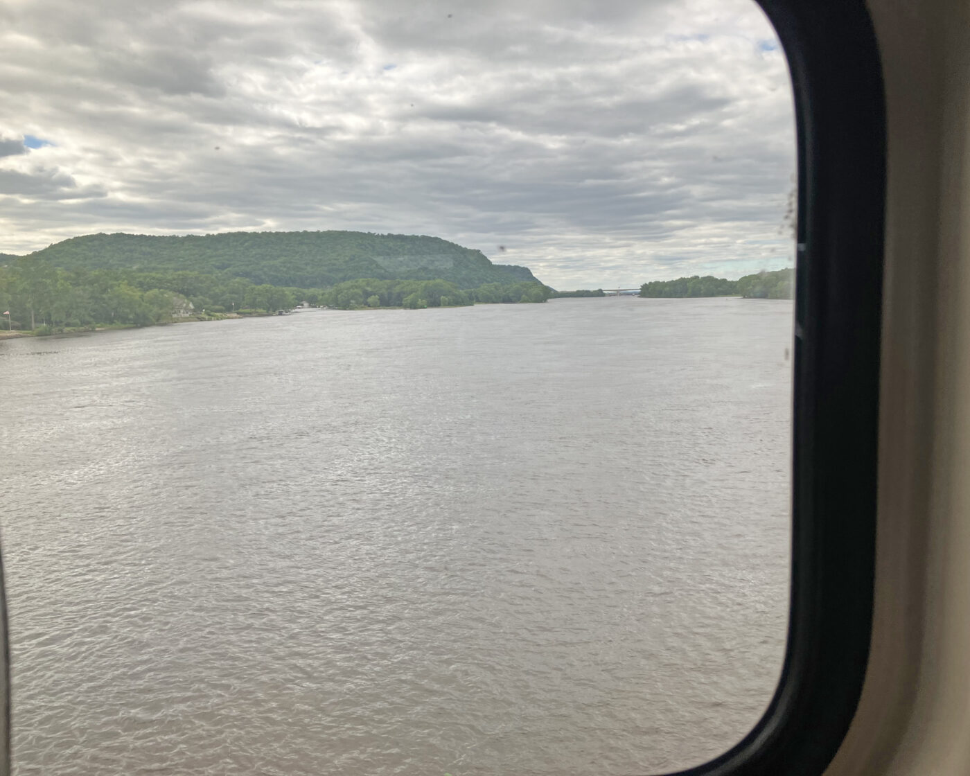 A wide expanse of the Mississippi River with green bluffs