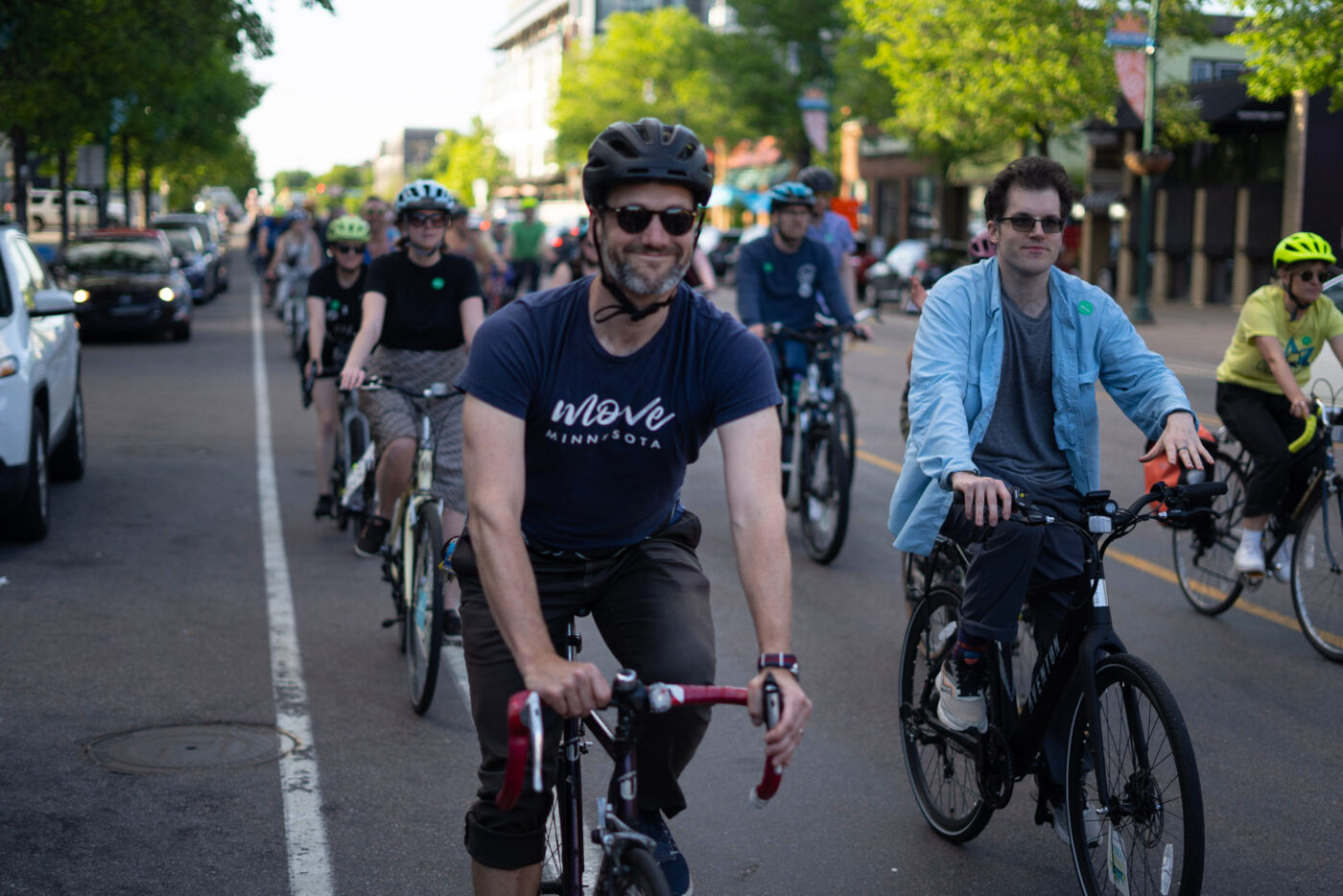 Sam Rockwell biking with a group during a Move Minnesota group ride on Lyndale Avenue in Minneapolis, Minnesota.