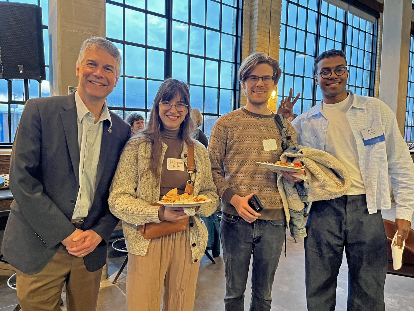 Rep. Larry Kraft stands with two transit advocates and Nas Nourkadi from Move Minnesota 