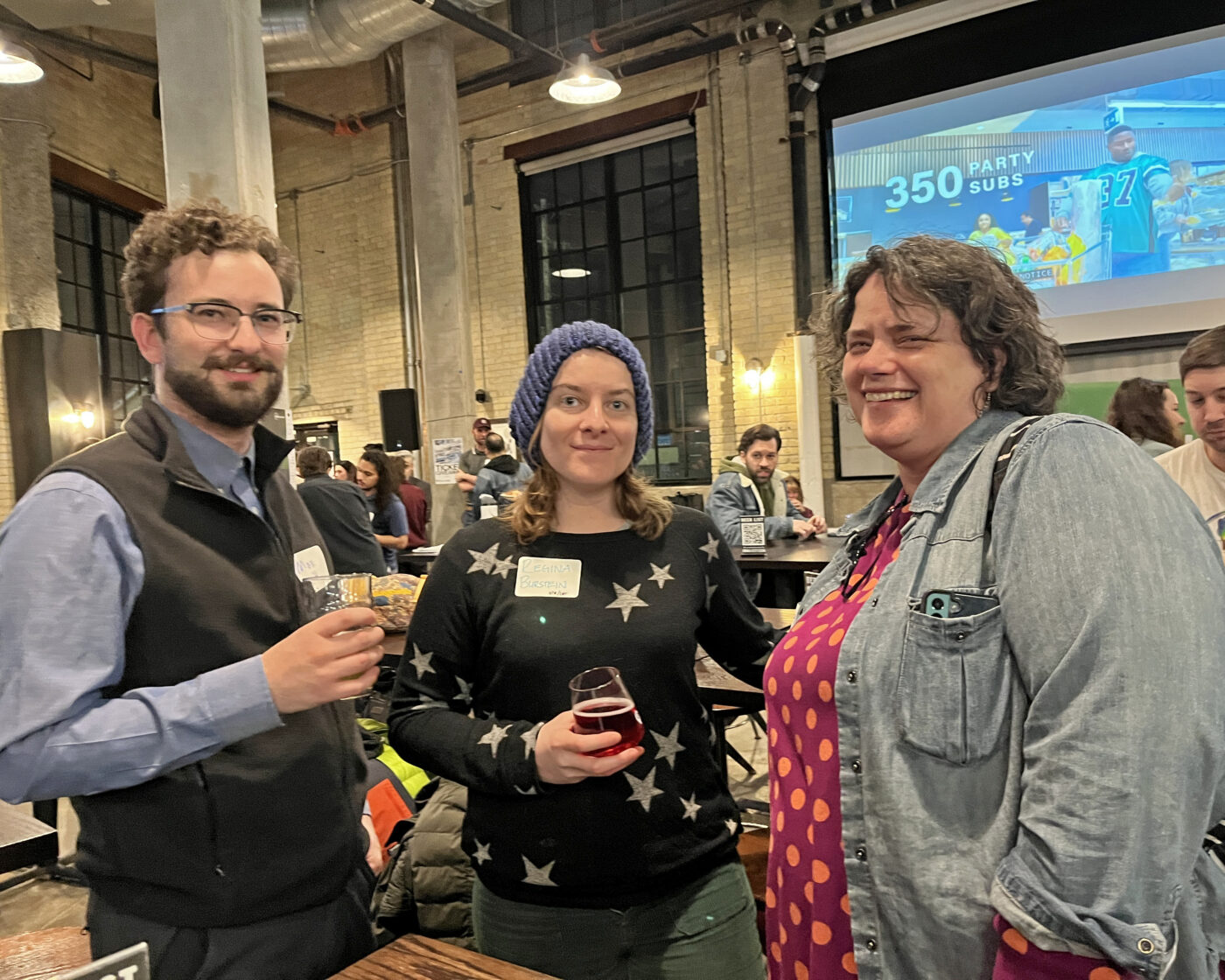 Two female and one male advocate chatting at the social 